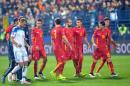 Montenegro's players leave the pitch after Russian goalkeeper Igor Akinfeev was hit by a flare thrown from the stands during the Euro 2016 Group G qualifying soccer match between Montenegro and Russia, at the City Stadium in Podgorica, Montenegro, Friday, March 27, 2015. (AP Photo/Risto Bozovic)