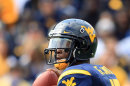 West Virginia quarterback Geno Smith (12) looks for a receiver during their NCAA college football game against Baylor in Morgantown, W.Va., Saturday, Sept. 29, 2012. (AP Photo/Christopher Jackson)