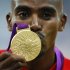 Britain's Mo Farah kisses his gold medal for the men's 5000m at the victory ceremony at the London 2012 Olympic Games