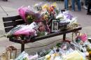 Floral tributes and a photograph of Arek Jozwik at the Harlow shopping centre where he was killed