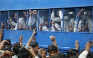 Some of the 32 people convicted for their role in one episode of the Gujarat riots are escorted to prison in a police vehicle outside a court in the western Indian city of Ahmedabad August 29, 2012. REUTERS/Amit Dave