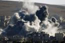 Explosion following an air strike is seen in central Kobani