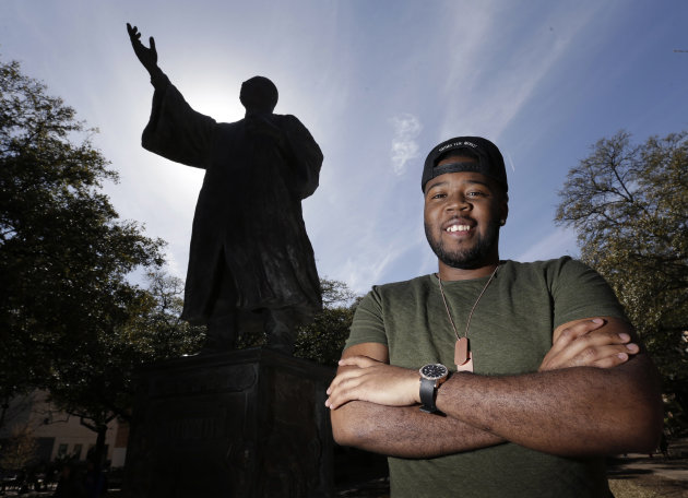 In this March 5, 2013 photo, University of Texas senior Bradley Poole poses for a photo on campus near the Martin Luther King Jr. statue in Austin, Texas. Poole, an advertising major, became president of the school's Black Student Alliance, seeking camaraderie after noticing he often was the only African-American in his classes. In two pivotal legal cases, one on affirmative action and another on voting rights, a divided U.S. Supreme Court may be poised in the coming weeks to rule that racism is largely a relic of America's past. The question is apt as the nation nears a demographic tipping point, when non-whites become the country's majority for the first time. (AP Photo/Eric Gay)