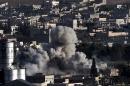Smoke rises after strikes from the US-led coalition in the Syrian town of Ain al-Arab, known as Kobane by the Kurds, on October 10, 2014