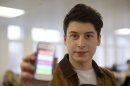 Nick d'Aloisio displays his mobile application Summly, as he poses for photographs after being interviewed by the Associated Press in London, Tuesday, March 26, 2013. One of Britain's youngest Internet entrepreneurs has hit the jackpot after selling his top selling mobile application Summly to search giant Yahoo. Seventeen year old Nick d'Aloisio, who dreamed up the idea for the content shortening program when he was studying for his exams, said he was surprised by the deal. As with its other recent acquisitions, Yahoo didn't disclose how much it is paying for Summly, although British newspapers suggested the deal's value at several million dollars. (AP Photo/Matt Dunham)