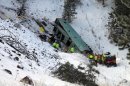 Emergency personnel respond to the scene of a multiple-fatality accident where a tour bus careened through a guardrail along an icy highway and several hundred feet down a steep embankment, authorities said, Sunday, Dec. 30, 2012 about 15 miles east of Pendleton, Ore. The charter bus carrying about 40 people lost control around 10:30 a.m. on the snow- and ice-covered lanes of Interstate 84, according to the Oregon State Police. (AP Photo/East Oregonian, Tim Trainor)