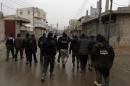 Opposition fighters from the Ahrar Al-Sham brigade walk in Aleppo during ongoing clashes with government forces on January 27, 2014