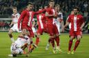 Germany's Benedikt Hoewedes, bottom, and Poland's Lukasz Szukala challenge for the ball during a friendly soccer match between Germany and Poland in Hamburg, Germany, Tuesday, May 13, 2014. (AP Photo/Matthias Schrader)