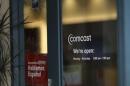 A Comcast sign is shown on the entrance to its store in San Francisco