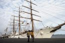 FILE - In this Oct. 23, 2012 file photo, port workers walk past the three-masted ARA Libertad, a symbol of Argentina's navy, as it lies docked at the port in Tema, outside Accra, Ghana. Sailors aboard the navy sailing ship seized in a billion-dollar international debt controversy brandished weapons to block Ghanaian officials from moving the vessel to a less busy dock, an official of the Ghana Ports and Harbors Authority said Saturday, Nov. 10, 2012. (AP Photo/Gabriela Barnuevo, File)