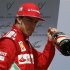 Ferrari Formula One driver Alonso of Spain holds a bottle of champagne after winning the German F1 Grand Prix at the Hockenheimring