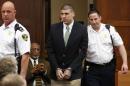 Former New England Patriots tight end Aaron Hernandez is led into the courtroom to be arraigned on homicide charges at Suffolk Superior Court in Boston, Wednesday, May 28, 2014. Hernandez pleaded not guilty in the shooting deaths of Daniel de Abreu and Safiro Furtado. He already faces charges in the 2013 killing of semi-pro football player Odin Lloyd. (AP Photo/Dominick Reuter, Pool)