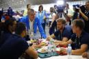 Tomas Bach, President of the International Olympic Committee, greets athletes in the dining hall after moving into the Olympic village in Rio de Janeiro, Brazil, July 28, 2016. (Ivan Alvarado/Pool Photo via AP)
