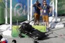 ADDS THAT MULTIPLE PEOPLE WERE INJURED - An overhead camera that fell from wires suspending it over Olympic Park lays on the ground at the Summer Games in Rio de Janeiro, Brazil, Monday, Aug. 15, 2016. A witness said the large camera, which moved back and forth along wires providing aerial views of the main Olympic park, fell when it was being examined on a bridge overlooking an arena entrance. At least seven people suffered minor injuries, according to the Olympic Broadcasting Service, and Rio organizers say at least one injured person was taken to a hospital. (AP Photo/Robert F. Bukaty)