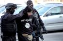 Bosnia and Herzegovina's State Agency for Investigations and Protection (SIPA) officers arresting a man on terrorism charges, April 15