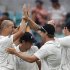 Teammates congratulate New Zealand's Martin after he took the wicket of Austrtalia's Hughes during the second test in Hobart
