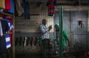 A man looks at his phone next to the Marche Total, the largest market in Brazzaville, ahead of presidential elections, on March 19, 2016