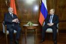 Russian President Vladimir Putin, right, listens to visiting Belarus counterpart, Alexander Lukashenko, in the presidential residence at Russian Black Sea resort of Sochi on Sunday, Feb. 8, 2015. The leaders of Germany, France, Russia and Ukraine aim to hold a summit in Minsk this week as they try to stem fighting in eastern Ukraine, officials said Sunday. The plan for a meeting Wednesday in the Belarus capital emerged from a phone call between German Chancellor Angela Merkel, French President Francois Hollande, Russian President Vladimir Putin and Ukrainian President Petro Poroshenko. Merkel's spokesman, Steffen Seibert, described the call as "intensive." (AP Photo/RIA Novosti Kremlin, Presidential Press Service)