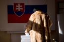 A woman casts her ballot during a referendum about same-sex marriage in Bratislava on February 7, 2015