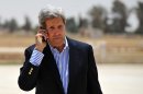 U.S. Secretary of State John Kerry speaks on the phone, before boarding a helicopter to Amman, at Mafraq air base after visiting the Zaatari refugee camp in Mafraq, Jordan, Thursday, July 18, 2013. Angry Syrian refugees urged Kerry on Thursday to do more to help opponents of President Bashar Assad's government, venting frustration at perceived inaction on their behalf. (AP Photo/Mandel Ngan, Pool)