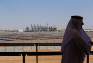 Homem observa de uma sacada a usina de energia solar concentrada Shams-1, nos arredores de Abu Dhabi