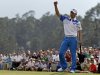 Amateur Guan Tianlang, of China, celebrates after a birdie putt on the 18th green during the first round of the Masters golf tournament Thursday, April 11, 2013, in Augusta, Ga. (AP Photo/Darron Cummings)