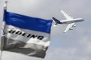 FILE - The June 25, 2011 file photo shows a Boeing flag fluttering as an Airbus A380 flies past during a demonstration flight at the 49th Paris Air Show at Le Bourget airport, east of Paris. The European Union seeks some US$ 12 billion in sanctions against the United States as part of a long-running dispute before the World Trade Organization involving subsidies to plane makers Airbus and Boeing. The Geneva-based trade body said Thursday, Sept. 27, 2012 that the EU plans request on Oct. 23 the right to impose the sanctions. (AP Photo/Francois Mori)