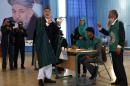 Afghan President Hamid Karzai shows his card before voting in the presidential election in Kabul