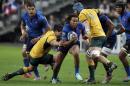 France rugby player Teddy Thomas, center, is tackled by Australia Christian Leali'Ifano, left and James Horville, right on his way to score a try during their rugby union international match at the Stade De France in Saint Denis, north of Paris, Saturday Nov. 15, 2014. (AP Photo/Francois Mori)