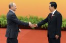 Chinese President Hu Jintao, right, shakes hands with Russian President Vladimir Putin at the Shanghai Cooperation Organization (SCO) summit in the Great Hall of the People in Beijing, China Thursday, June 7, 2012. (AP Photo/Mark Ralston, Pool)