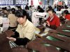 Employees work at a shoe factory in Dongkou county, Hunan province