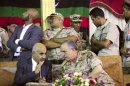 Libya's President Mohammed Magarief and Libyan Army Chief of Staff Yousef al-Mangush speak during their visit to the tomb of Omar al-Mukhtar in Suluq