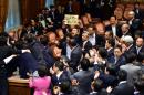 Japanese ruling and opposition lawmakers scuffle at the Upper House's ad hoc committee session for the controversial security bills at the National Diet in Tokyo on September 17, 2015