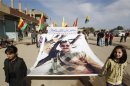 Syrian Kurds demonstrators hold a portrait of jailed Kurdistan Workers Party leader Ocalan during a protest in Derik