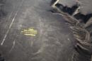 Greenpeace activists stand next to massive letters delivering the message "Time for Change: The Future is Renewable" next to the hummingbird geoglyph in Nazca in Peru, Monday, Dec. 8, 2014. Greenpeace activists from Brazil, Argentina, Chile, Spain, Germany, Italy and Austria displayed the message, which can be viewed from the sky, during the climate talks in Peru, to honor the Nazca people, whose ancient geoglyphs are one of the country's cultural landmarks. (AP Photo/Rodrigo Abd)
