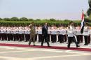 In this photo released by the Syrian official news agency SANA, Syria's President Bashar Assad, center, reviews the honor guard upon his arrival at the presidential palace to take the oath of office for his third, seven-year term, in Damascus, Syria, Wednesday July 16, 2014. Proclaiming the Syrian people winners in a "dirty war" waged by outsiders, President Bashar Assad was sworn in on Wednesday, marking the start of his third seven-year term in office amid a bloody civil war that has ravaged the Arab country. (AP Photo/SANA)