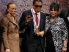 Boxing great Muhammad Ali waves after being awarded the Liberty Medal, as his wife Lonnie and sister-in-law Marilyn Williams look on, at the National Constitution Center in Philadelphia
