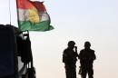 Iraqi Kurdish Peshmerga fighters hold a position on the front line in Khazer, west of Arbil on September 16, 2014