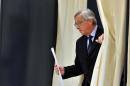 Luxembourg Prime Minister Jean-Claude Juncker leaves a voting booth at the Cultural Center of Capellen in Luxembourg on October 20, 2013