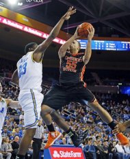 Oregon State guard Roberto Nelson (55) shoots as UCLA's Travis Parker (23) defends in the first half of an NCAA college basketball game in Los Angeles Thursday, Jan. 17, 2013. UCLA won 74-64. (AP Photo/Reed Saxon)