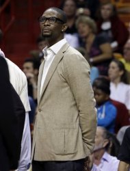 Miami Heat's Chris Bosh watches from the sidelines in the second half of an NBA basketball game against the Philadelphia 76ers, Saturday, April 6, 2013, in Miami. The Heat won 106-87. Bosh did not play due to a sore right knee. (AP Photo/Lynne Sladky)