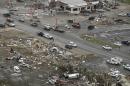 Homes and businesses are wrecked in downton Vilonia, Ark., Monday, April 28, 2014 after a tornado struck the town late Sunday. The most powerful twister this year carved an 80-mile path of destruction through suburbs north of the state capital of Little Rock, killing at least 16 people. (AP Photo/Danny Johnston)