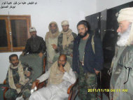 This image provided by the Libyan Youth Movement that was taken Saturday, Nov. 19, 2011 purports to show Seif al-Islam Gadhafi surrounded by revolutionary fighters following his capture near the Niger border with Libya. Moammar Gadhafi's son, the only wanted member of the ousted ruling family to remain at large, was captured as he traveled with aides in a convoy in Libya's southern desert. (AP Photo/Libyan Youth Movement) EDITORIAL USE ONLY; LOGO MUST BE USED; MANDATORY CREDIT