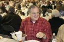 In this Saturday, Jan. 11, 2014 photo, U.S. Sen. Mark Pryor, D-Ark., holds a pan of raccoon meat at the Gillett Coon Supper in Gillett, Ark. Pryor faces a challenge from Republican Tom Cotton in the 2014 election. (AP Photo/Danny Johnston)