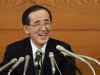 Outgoing Bank of Japan Governor Masaaki Shirakawa smiles during his last news conference as head of the central bank, in Tokyo