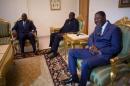 Senegalese President Sall and Beninois President Boni Yayi pose for a picture with Burkinabe transitional President Kafando at the president's residence in Ouagadougou