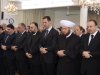 In this photo released by the Syrian official news agency SANA, Syrian President Bashar Assad, center, prays at a mosque on the first day of Eid al-Adha, Friday, Oct. 26, 2012. Fighting raged near a military base in Syria's north as a cease-fire in the bloody civil war was supposed to go into effect Friday at dawn, activists said, illustrating the difficulty of enforcing even a limited truce coinciding with a Muslim holiday. (AP Photo/SANA)
