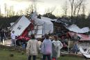 People examine a barn owned by the Miller family that was destroyed during a storm south of Mount Olive, Miss., Monday, Jan. 2, 2017. Forecasters say damaging winds, hail and flash flooding will be possible on Monday as a storm system moves across the South. (Ryan Moore/WDAM-TV via AP)