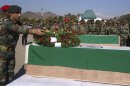 An Indian Army personnel places a wreath on a coffin containing the body of a colleague at a garrison in Rajouri district