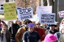 People march to voice their disapproval of U.S. President Donald Trump's policies downtown Boulder